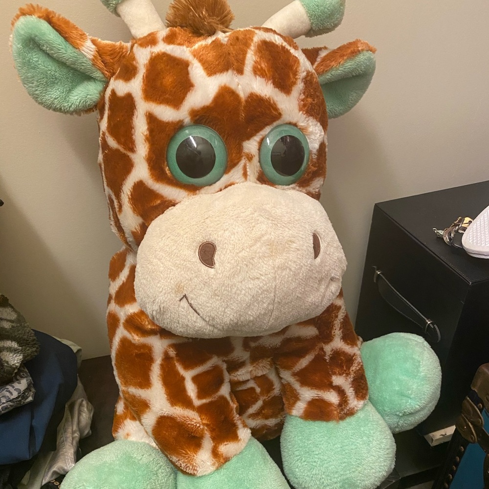 Big stuffed giraffe with green eyes and detail